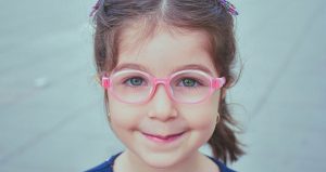 Little girl with pink glasses