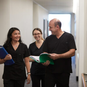 Cerulea walking down a hallway, looking at paperwork
