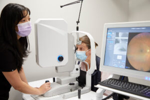 A participant has her eyes scanned by a large camera.